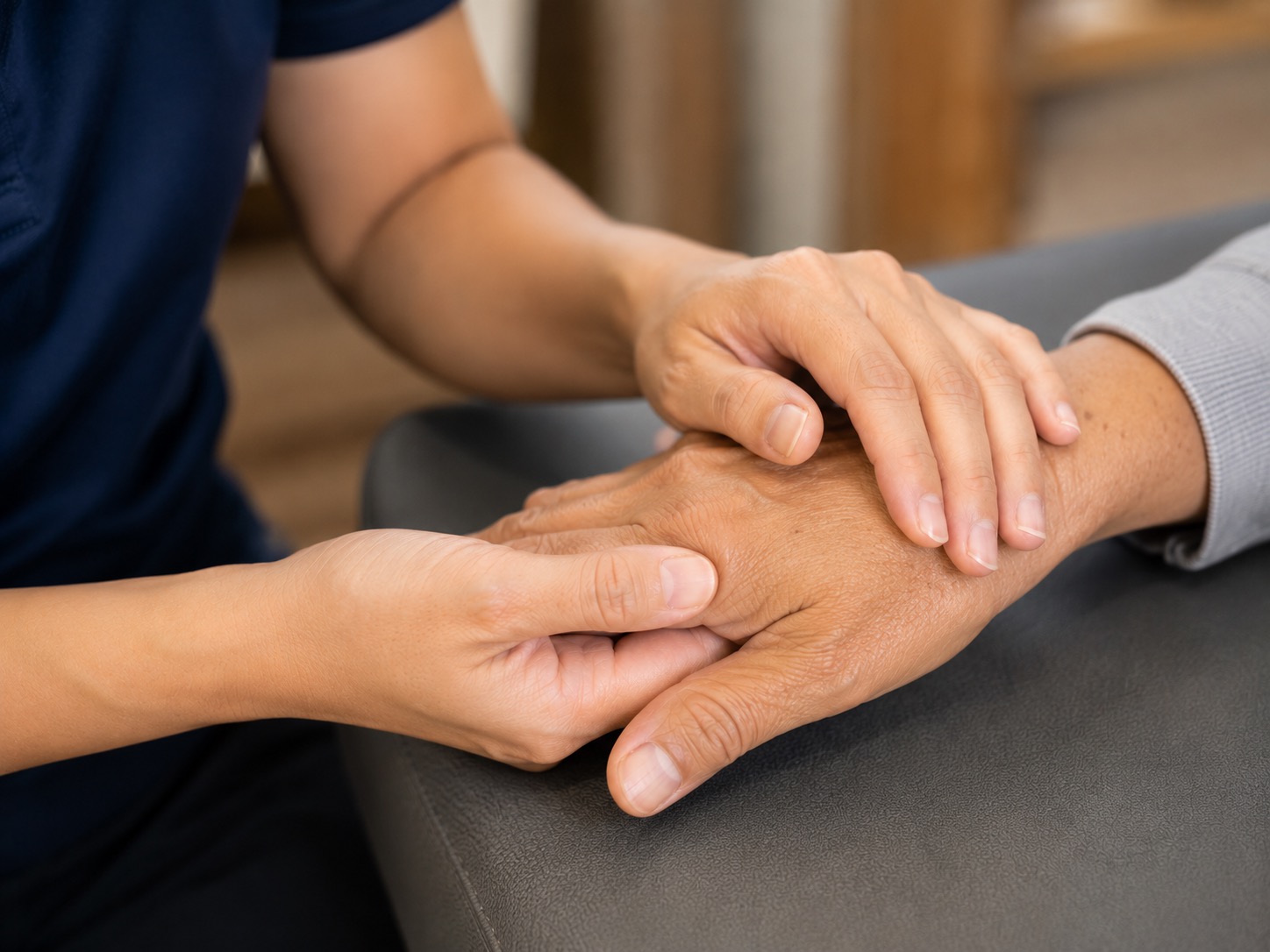 Michiko supporting a patient during post-stroke rehabilitation at home